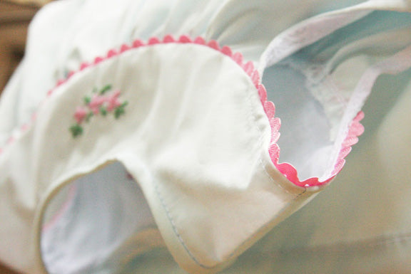 baby dress in pastel blue with floral embroidery